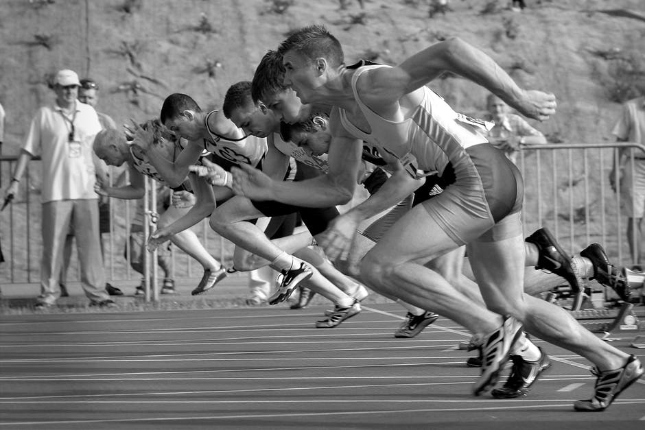 A race track with many runners doing what looks like a race or a speed workout